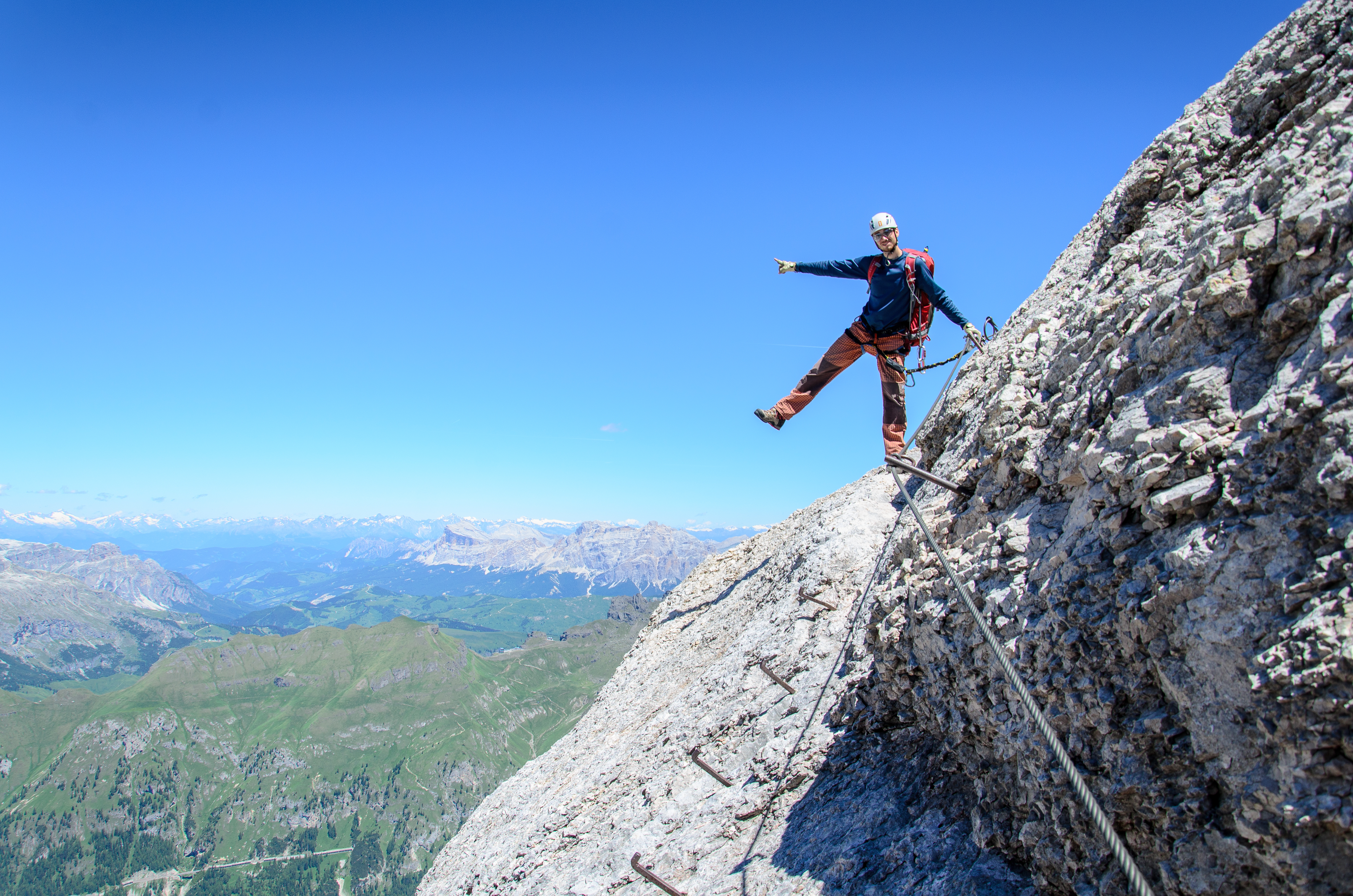 person standing with one leg off mountain cliff