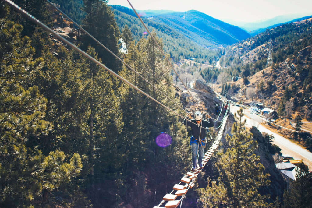 A man crossing the bridge on our Via Ferrata course