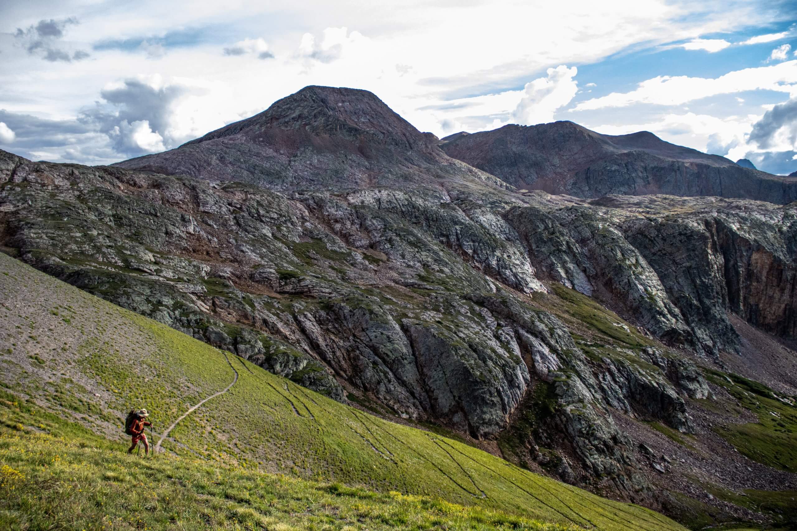 Man hiking across Colorado mountains