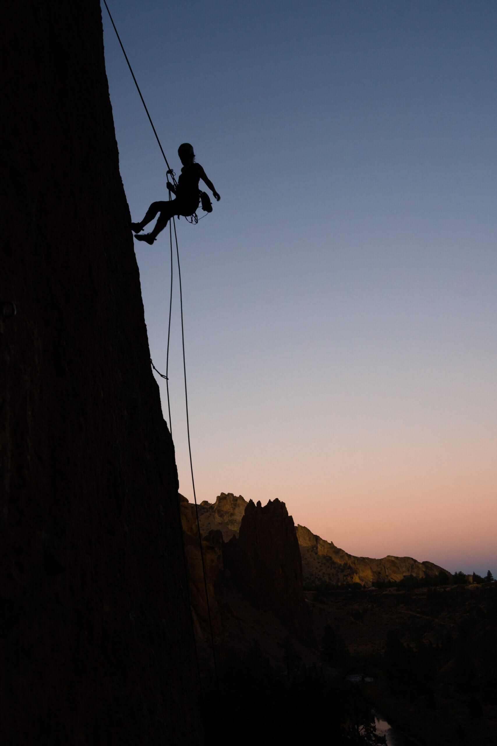 rappelling down cliffside