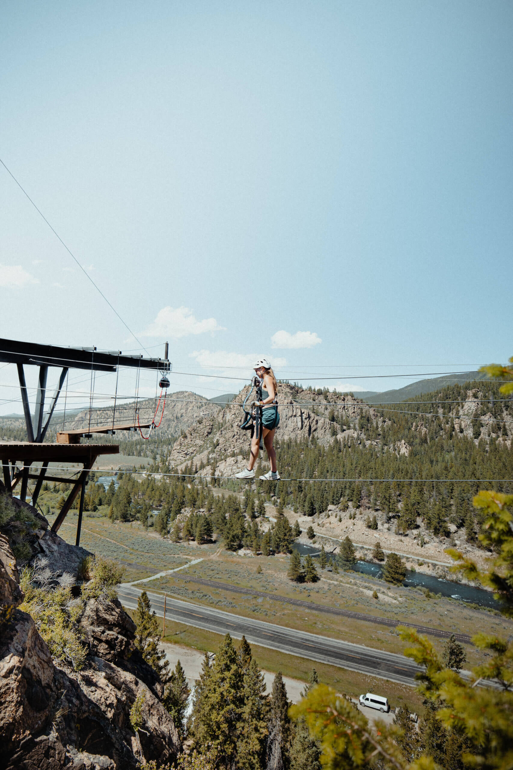 woman on Via Ferrata course, high above trees