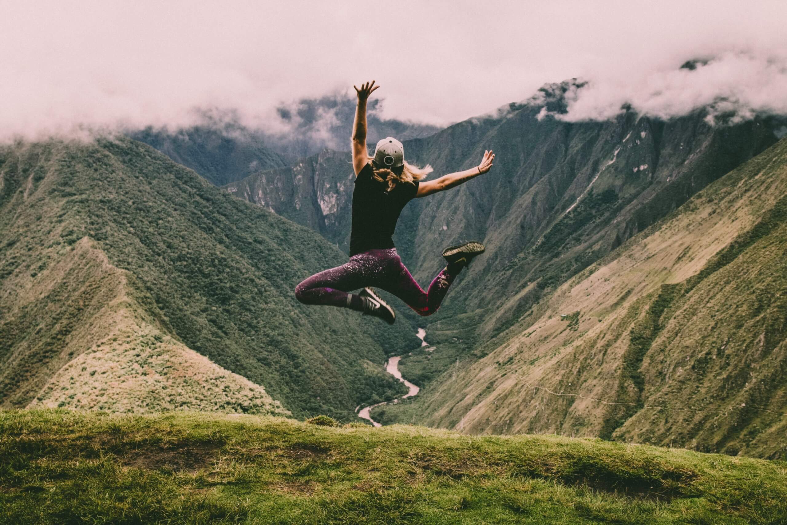 woman jumping in the mountains