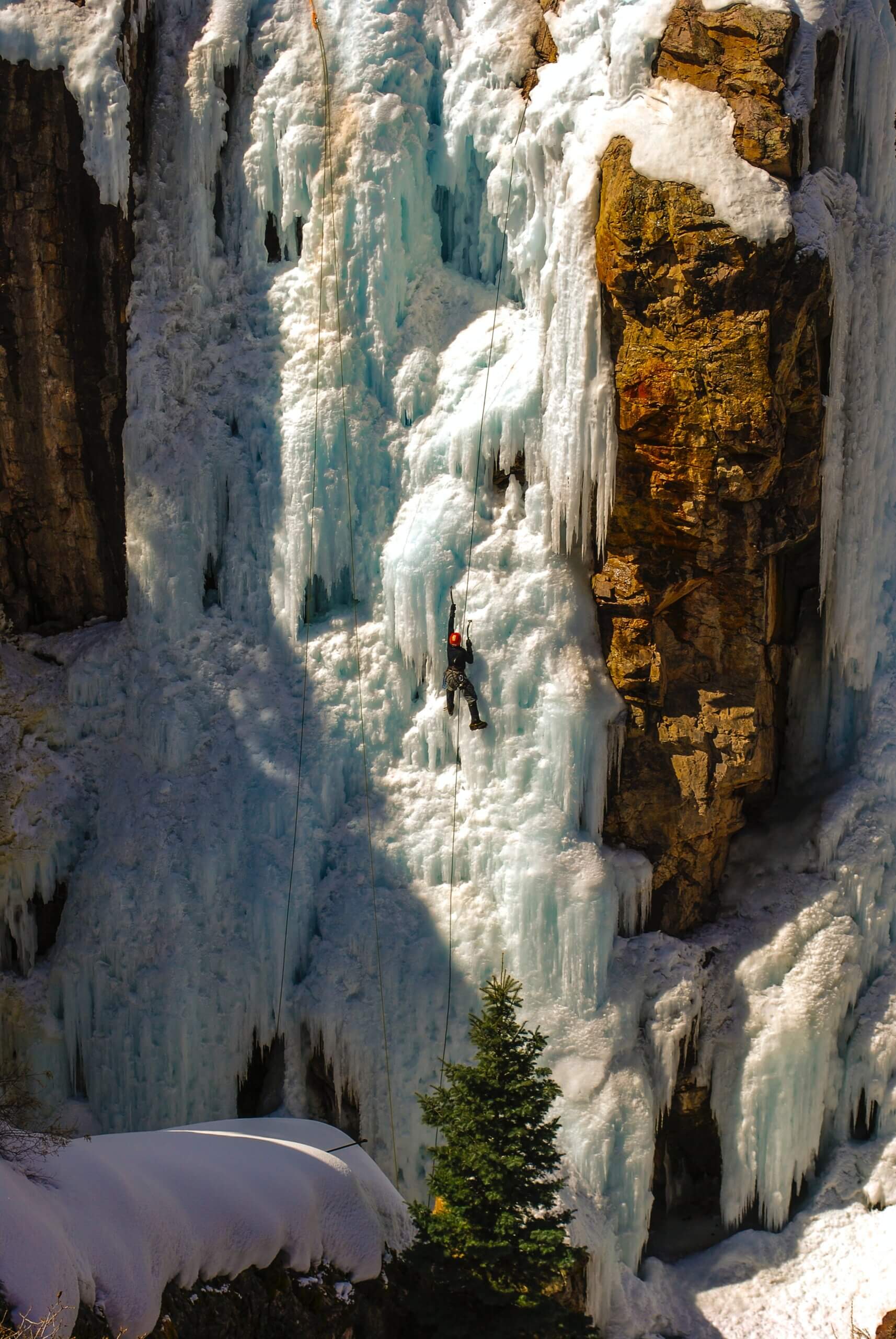 person climbing frozen waterfall in Ouray, Colorado